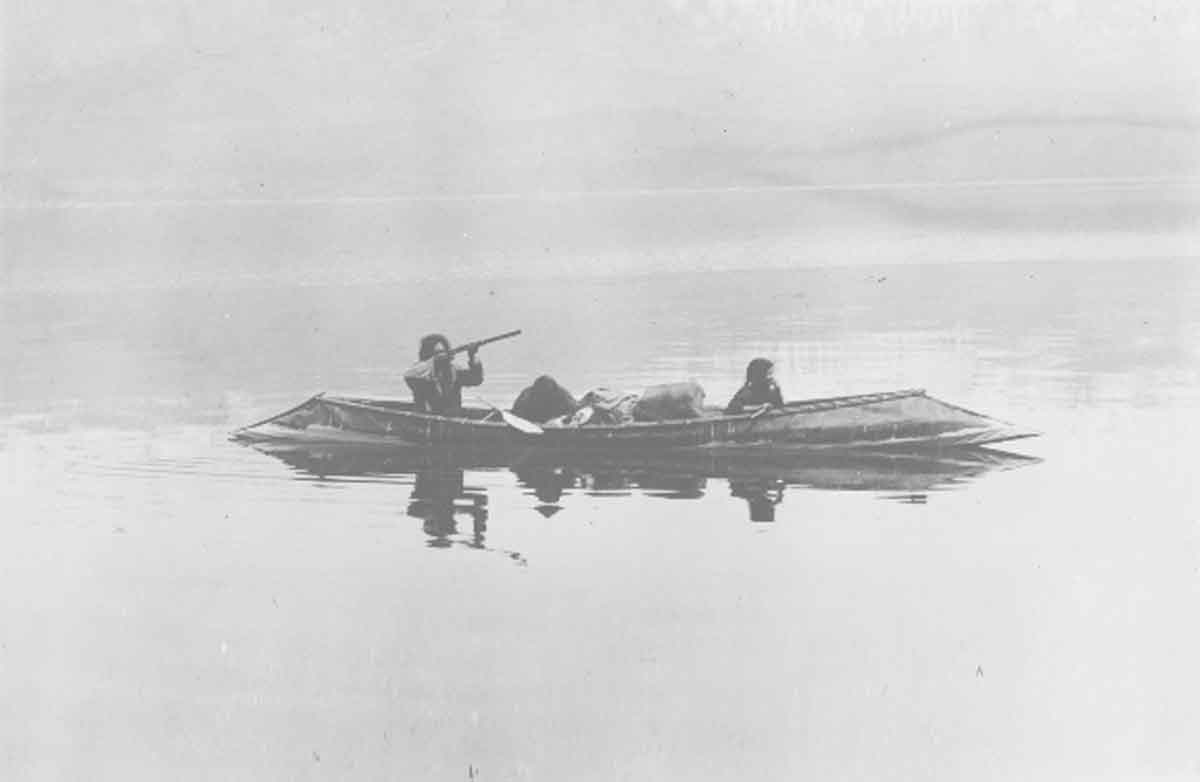 Native family in Sturgeon nosed canoe on Kootenay Lake